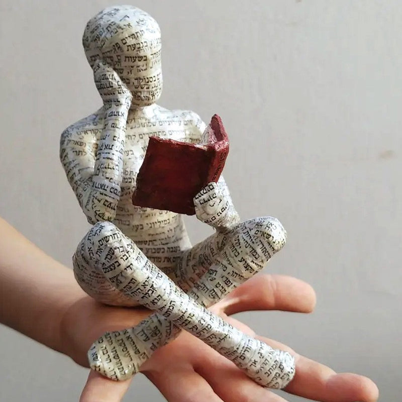 Resin Reading Statue Featuring Newspaper Print Design